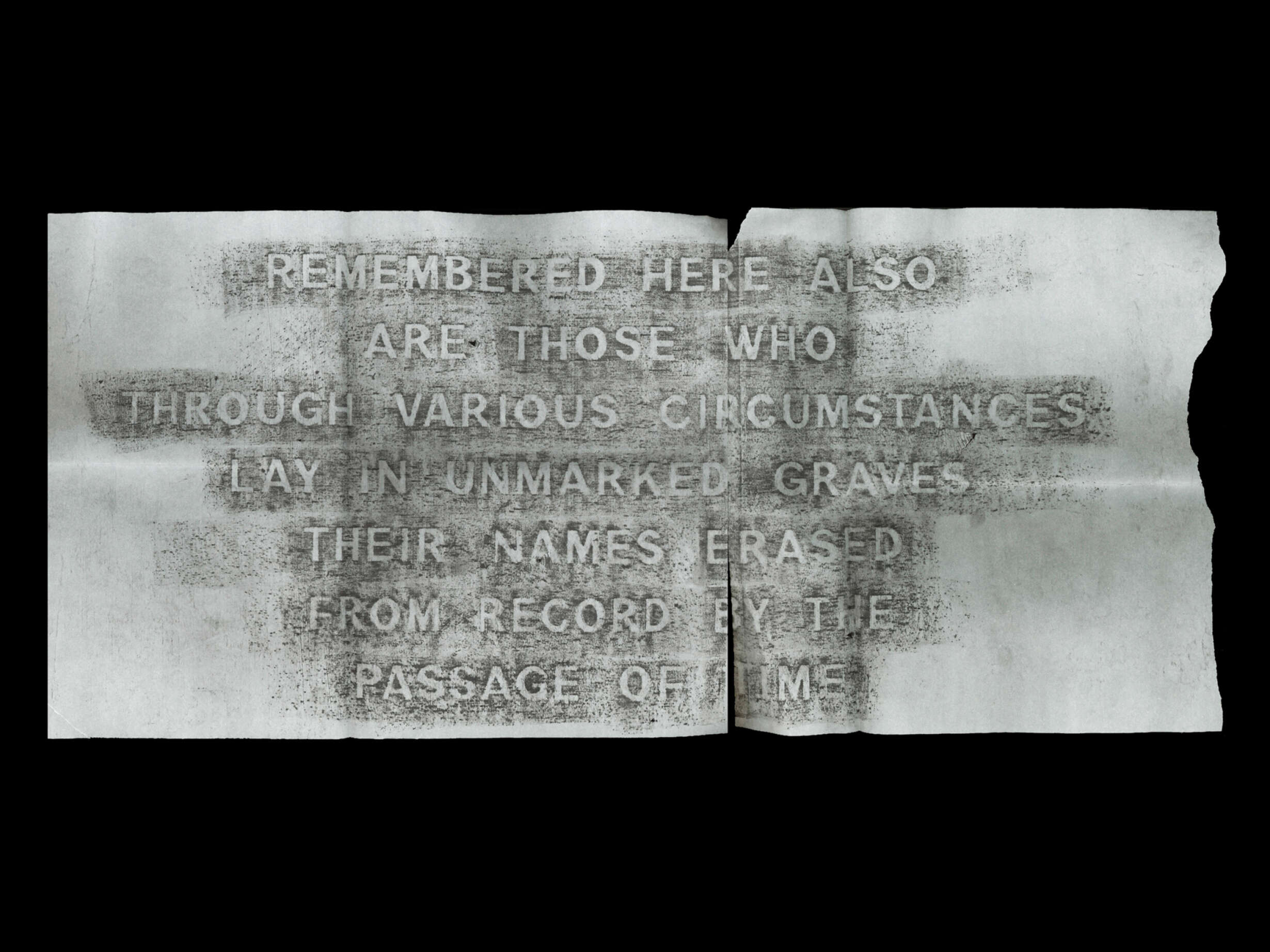Rubbing of the mass memorial, corner of Symonds Street and Karangahape Road, that commemorates the graves disturbed by the motorway. Charcoal on newsprint, 690x297mm.