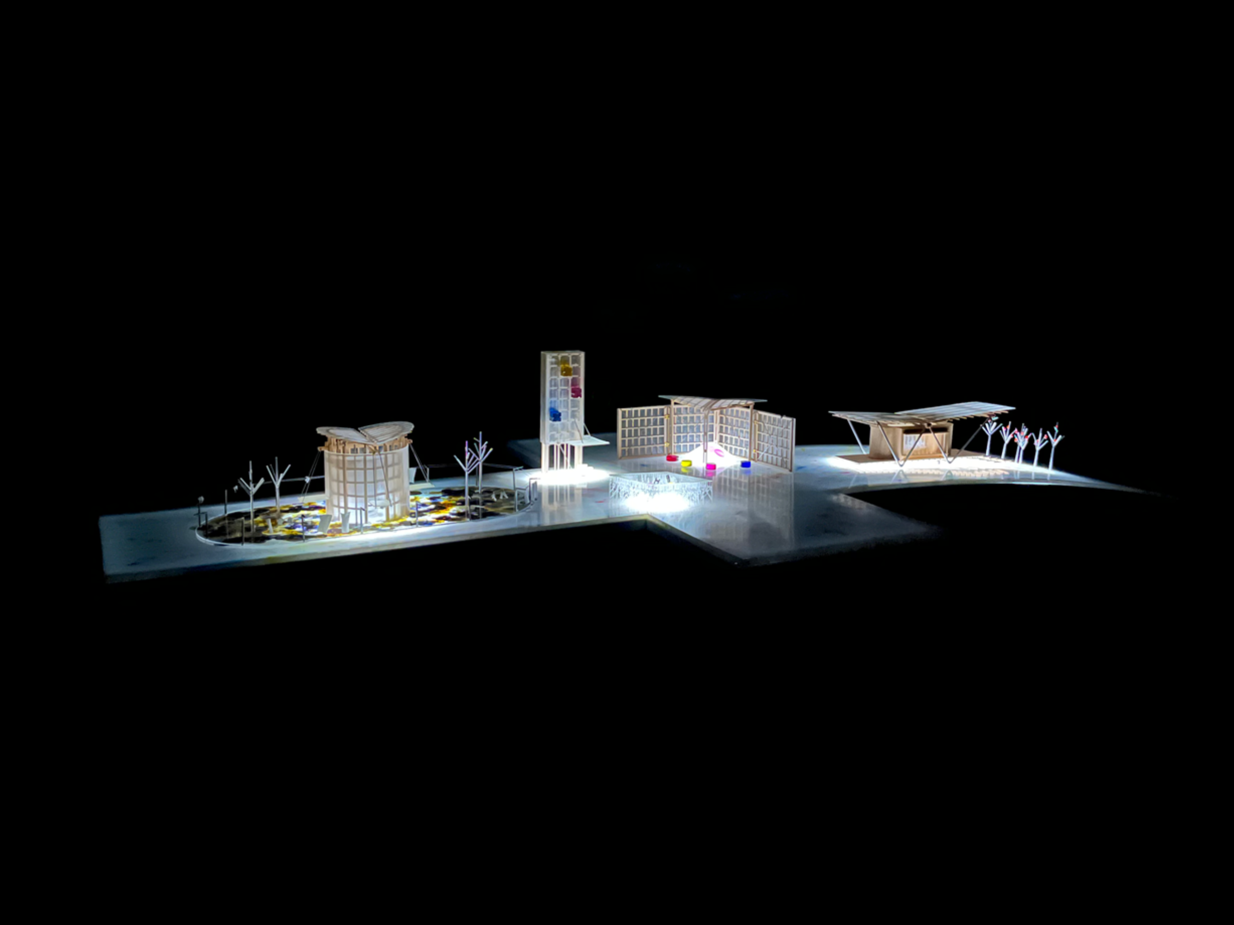 Final speculative street with the four illuminated speculative lighthouses. The speculative street is made of recycled plastic milk bottles on a thin white steel frame.